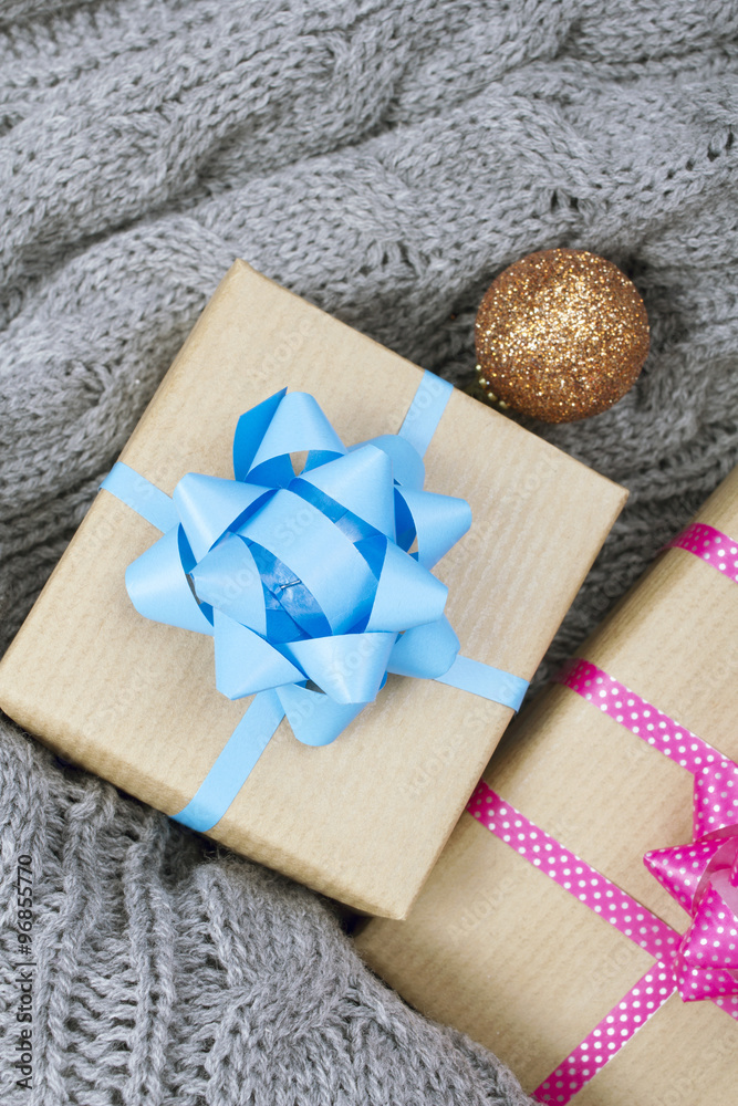 Christmas presents on a gray knitted background Christmas presents on a gray knitted background