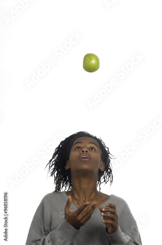 Teenage girl jugglery an apple