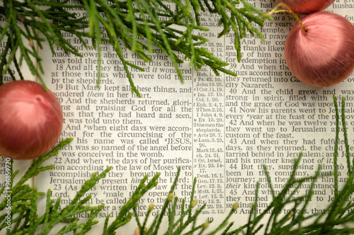 Christmas story, open Bible with ornaments and greenery