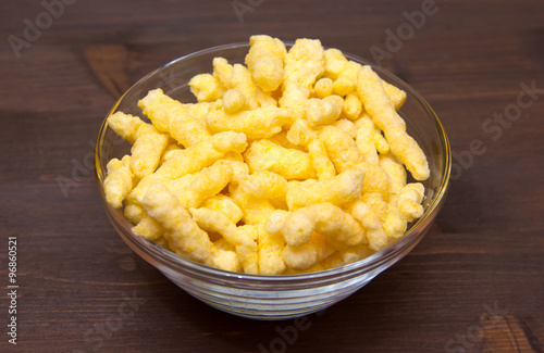 Snack corn cheese in bowl on wooden table