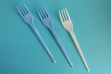 Blue and white fork on blue background - party time concept