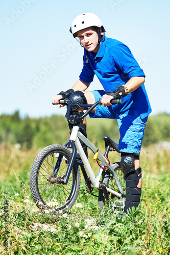 cyclist with his bicycle bike on meadow