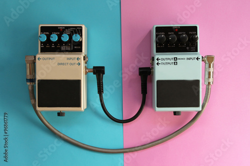 Guitar pedals on half blue half pink background - music concept photo