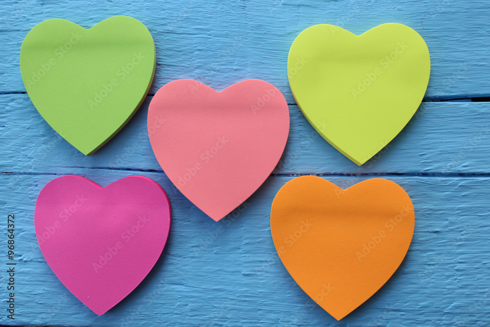 Blank pink paper note with heart shape on grunge blue wooden background with copy space Blank pink paper note with heart shape on grunge blue wooden background with copy space