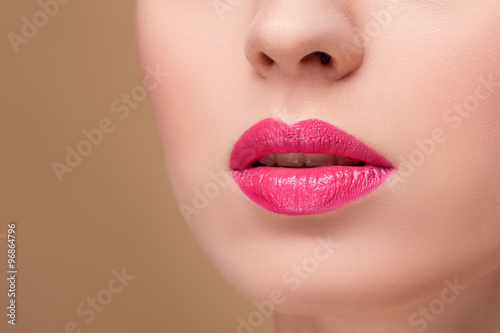 Cute young woman is receiving make-up treatment