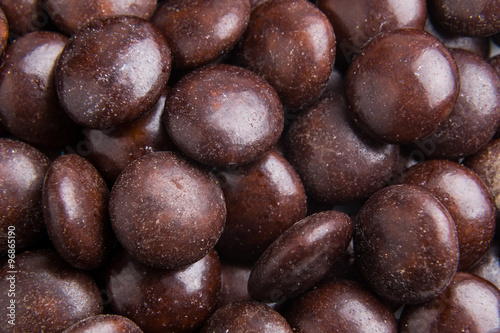 Close up on pile brown milk chocolate candies crisp shell