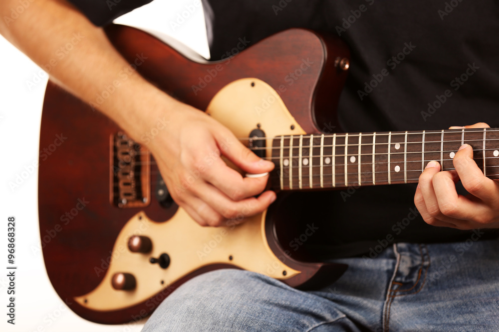 Fototapeta premium Young musician playing electric guitar close up