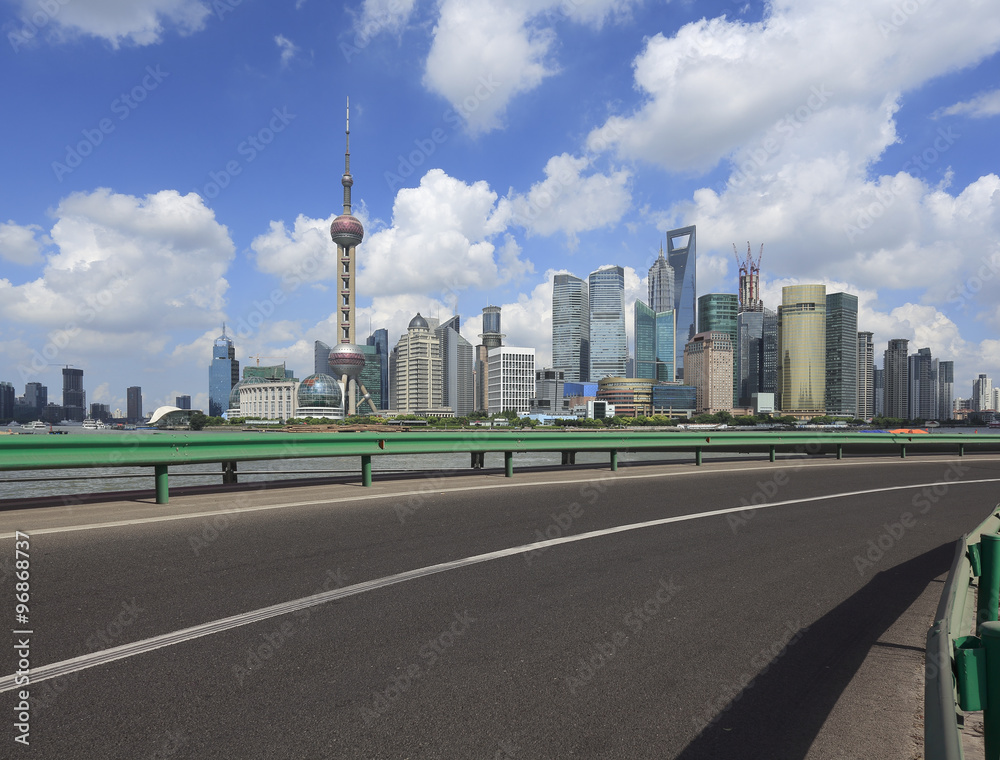 Fototapeta premium Empty road surface with shanghai bund city buildings