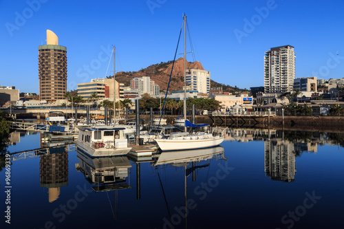 River reflections of boats and buildings on Ross Creek, Townsville, Queensland.