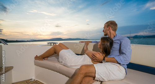 Romantic vacation . Beautiful couple  looking in sunset  from the yacht © upslim