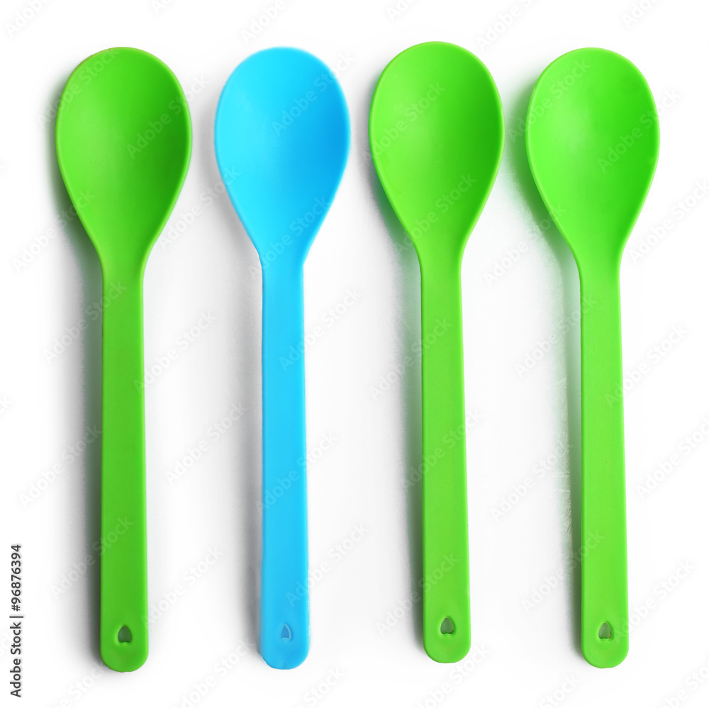 Disposable colourful spoons, isolated on white, top view, Individuality concept Disposable colourful spoons, isolated on white, top view, Individuality concept