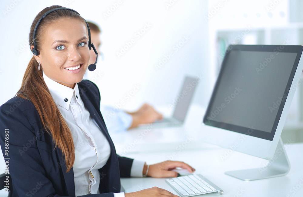 Happy female wearing headset and sitting on the desk Happy female wearing headset and sitting on the desk