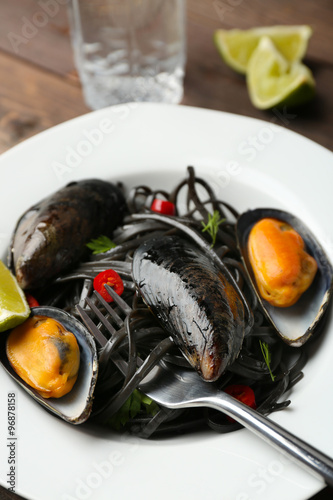 Cooked pasta, mussel and lime on the table, close-up