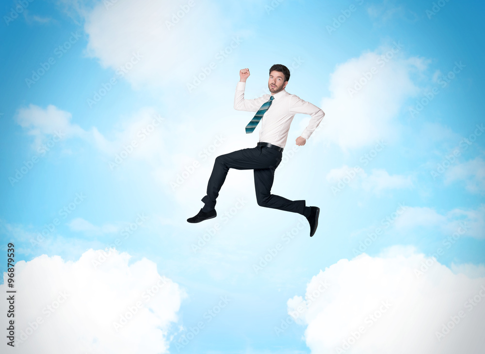 Business person jumping over clouds in the sky Business person jumping over clouds in the sky