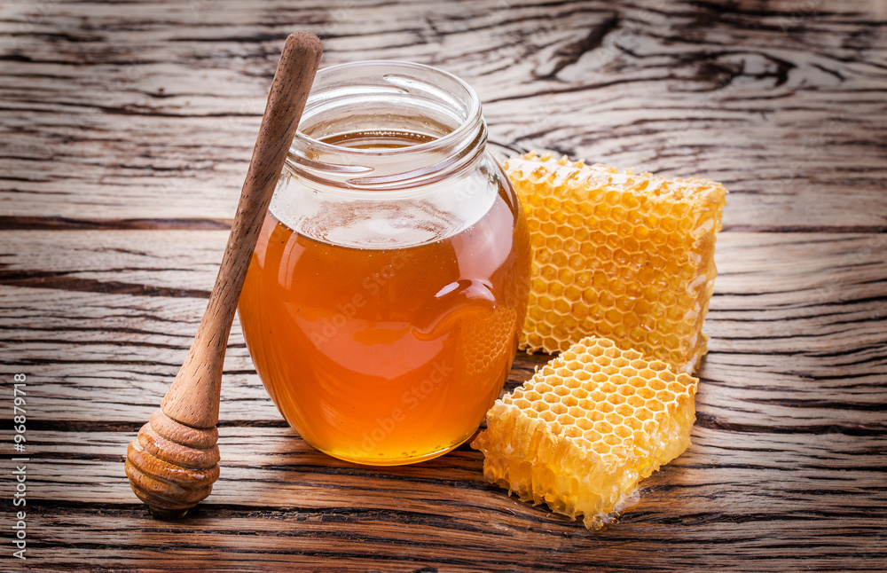 Jar full of fresh honey and honeycombs. High-quality picture. Jar full of fresh honey and honeycombs. High-quality picture.