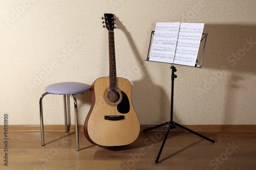 Acoustic guitar propped on ...