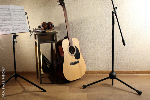 Acoustic guitar propped on ...