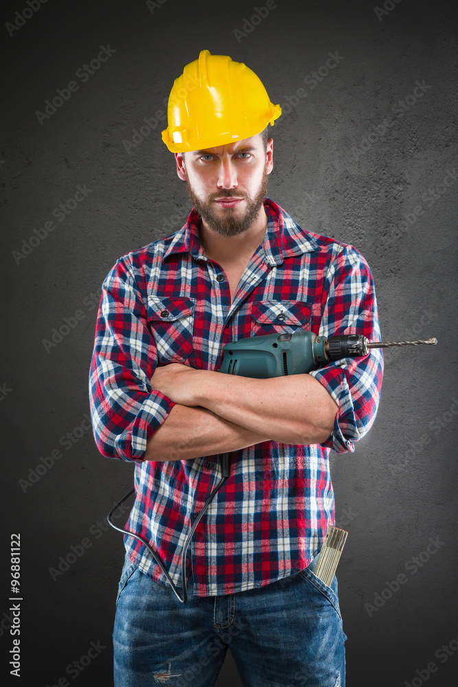 Attractive young workman with drill