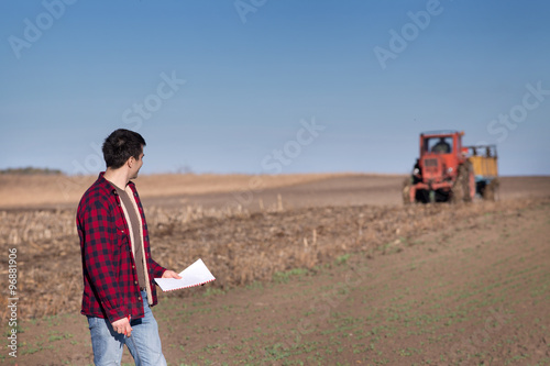 Photography Farmer with tractor on field