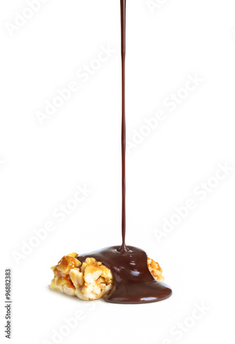 melted chocolate is poured on nuts caramel