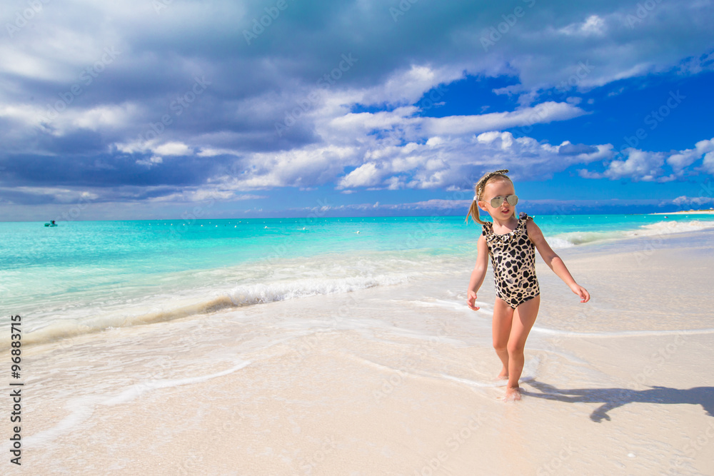 Adorable little girl at beach during summer vacation Adorable little girl at beach during summer vacation