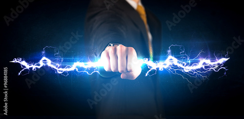 Business man holding electricity light bolt in his hands