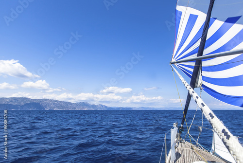 Sailing ship yachts with blue white sails in the Sea. Luxury boats. .