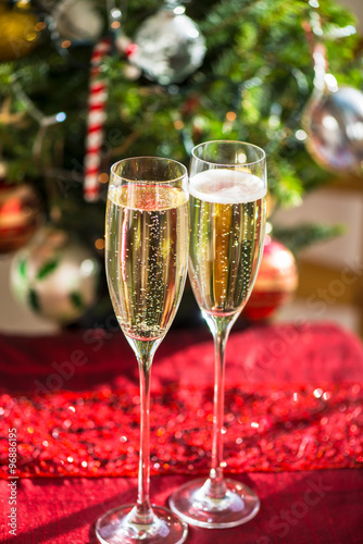 Two Champagne Flutes on Christmas Background