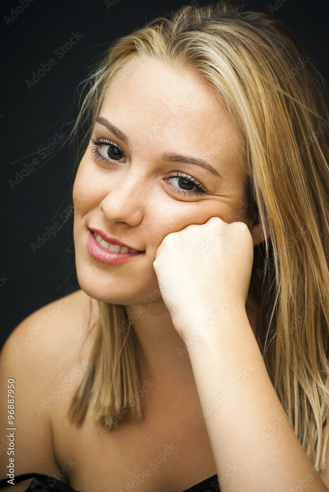 Portrait of Beautiful Young Woman resting her face in her hand Portrait of Beautiful Young Woman resting her face in her hand