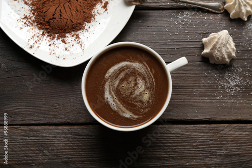 Cup of coffee with kisses on wooden background