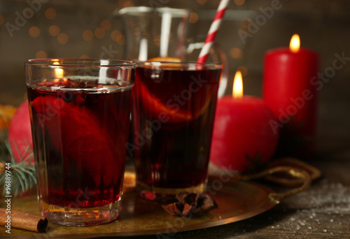 Decorated composition of mulled wine in glasses on wooden table, close up