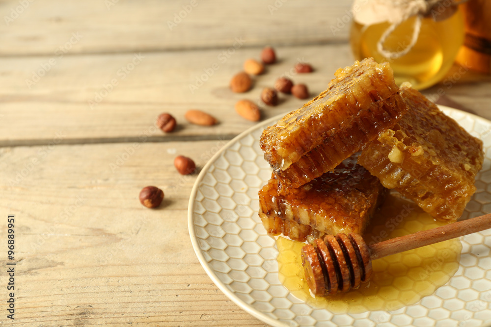 Honeycombs on plate on wooden background Honeycombs on plate on wooden background