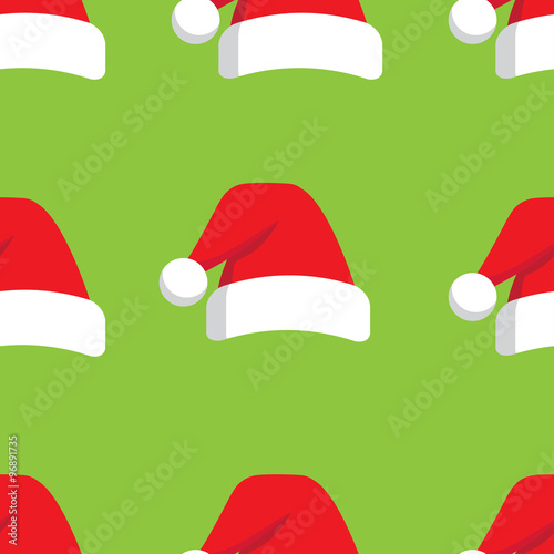 seamless pattern which repeats Christmas hat on a green background