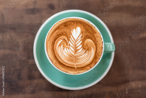 Hot Coffee in Green Cup on Wooden Background