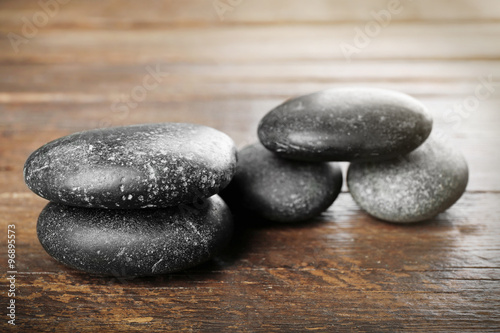 Spa stones on wooden background
