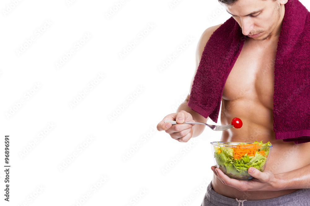 Fit young man holding a bowl of salad, isolated on white backgro Fit young man holding a bowl of salad, isolated on white backgro