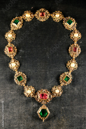 Antique jewelry golden chain with large precious gems.