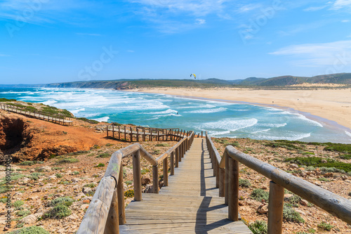Fototapeta Naklejka Na Ścianę i Meble -  Wooden walkway to Praia do Bordeira beach and beautiful blue sea view, Algarve region, Portugal