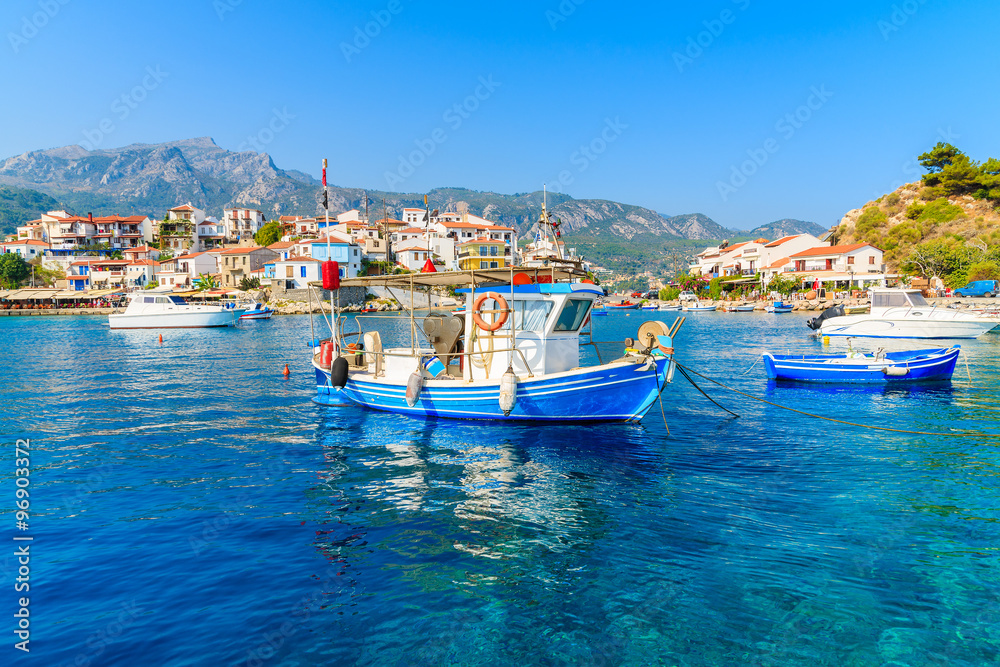 Typical blue and white colour fishing boat in Kokkari port, Samos island, Greece