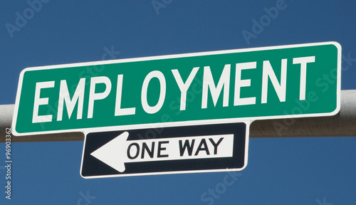 Employment printed on green overhead highway sign with one way arrow 