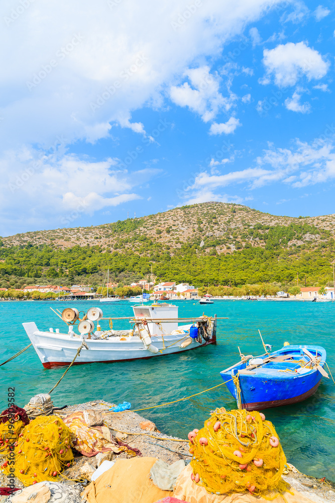 Colorful Greek fishing boats with nets on shore in Posidonio bay, Samos island, Greece