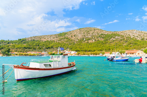Traditional Greek fishing boat on turquoise sea water in Posidonio bay, Samos island, Greece © pkazmierczak