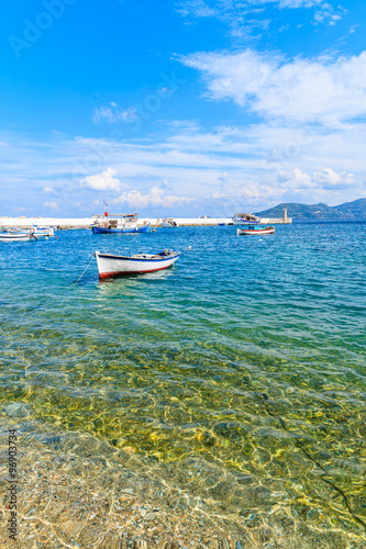 Traditional Greek fishing boat on blue sea in Kokkari bay, Samos island, Greece