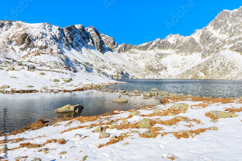 View of lake in Hincova valley covered with snow, Tatra Mountains, Slovakia photo