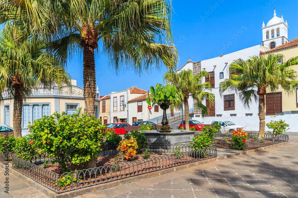 Square with tropical plants and typical Canary style buildings in Garachico old town, Tenerife, Canary Islands, Spain