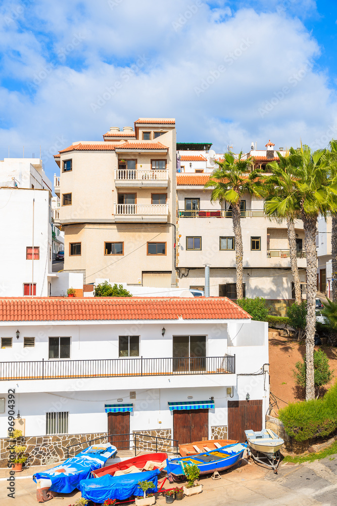 Fototapeta premium Fishing boats in Alcala town with typical Canarian architecture on coast of Tenerife, Canary Islands, Spain