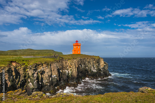 Orange lighthouse at seashore of Grimsey island nearby Iceland,