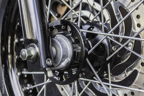 Motorcycle wheel in black and white with ABS brakes.