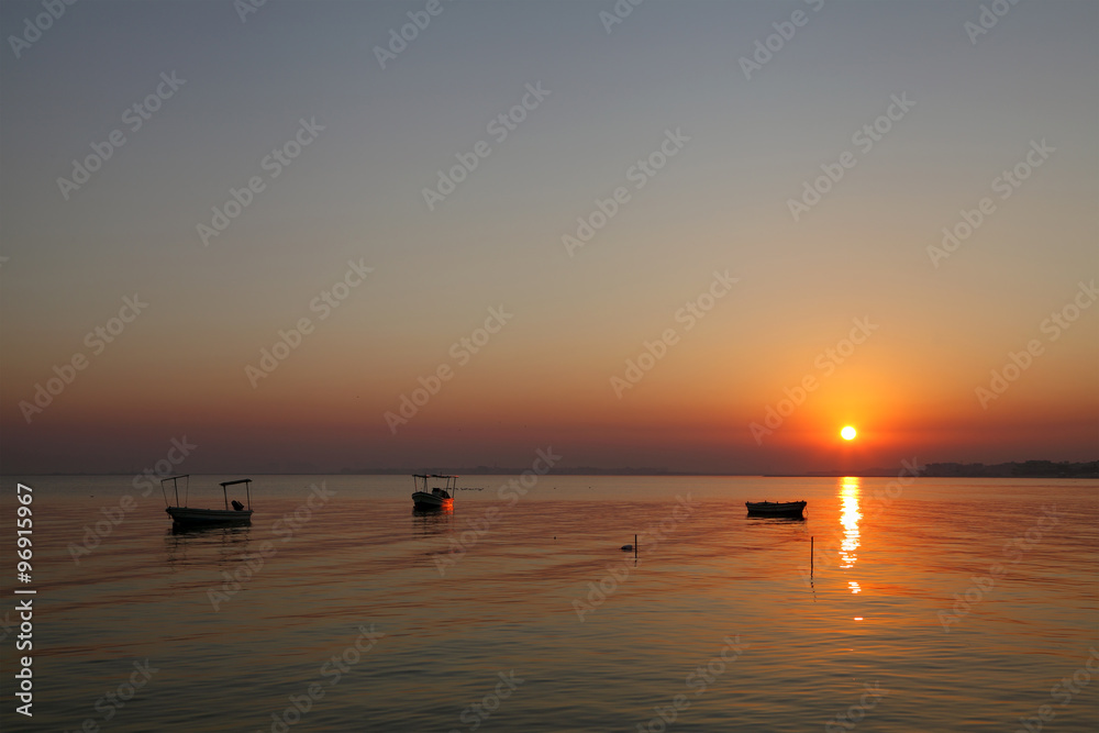 Boats harbored at Busaiteen beach during dawn