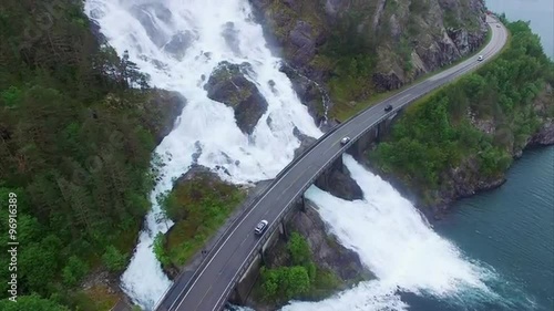 Aerial footage of road traffic on the bridge overstretching massive waterfall Langfossen in Norway. Aerial 4k Ultra HD.